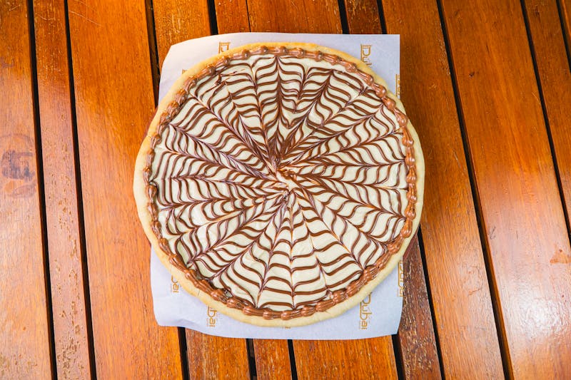 Cinnamon dessert pizza with vanilla glaze and strawberries