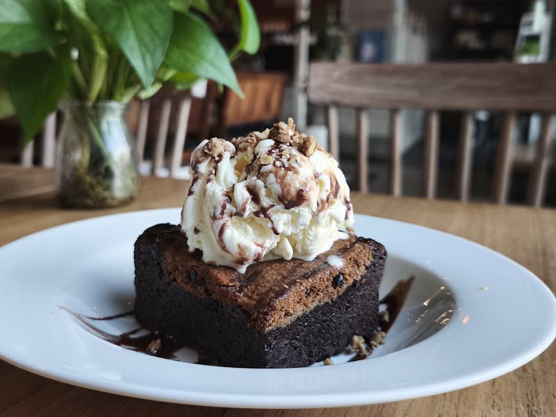 Warm chocolate brownie with vanilla ice cream scoop