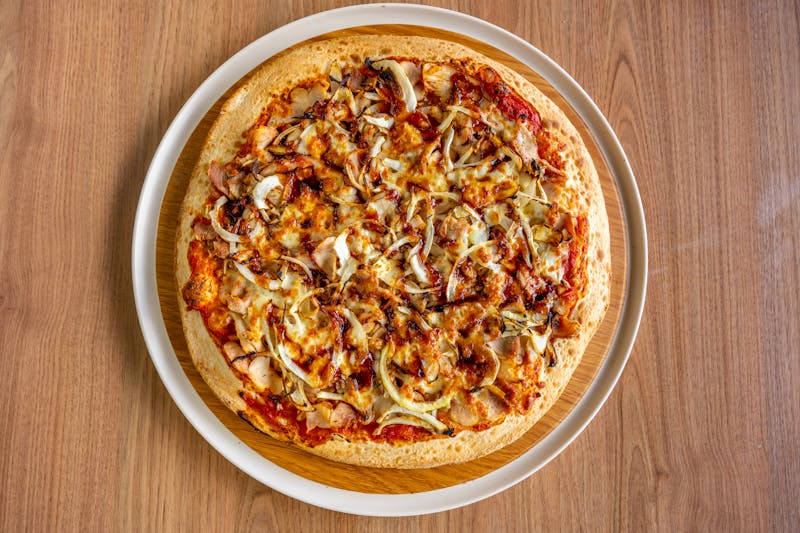 BBQ Chicken pizza with smoky sauce and red onions